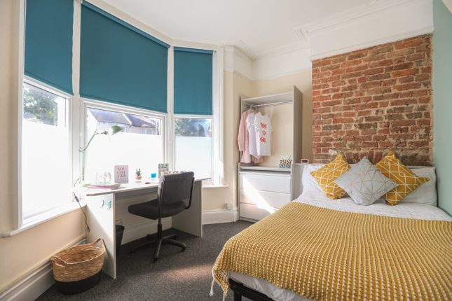 Bright And Cozy Bedroom Featuring A Comfortable Be...