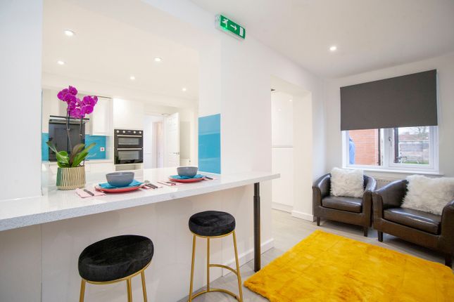 A Clean And Modern Living Room With Stylish Furnit...