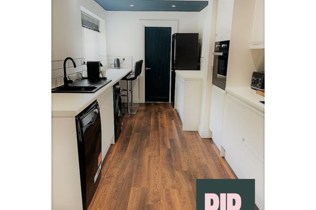 A Modern And Spacious Kitchen, Featuring Sleek App...