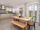 An Open Plan Kitchen And Dining Area Leads Through Double Doors To The Garden