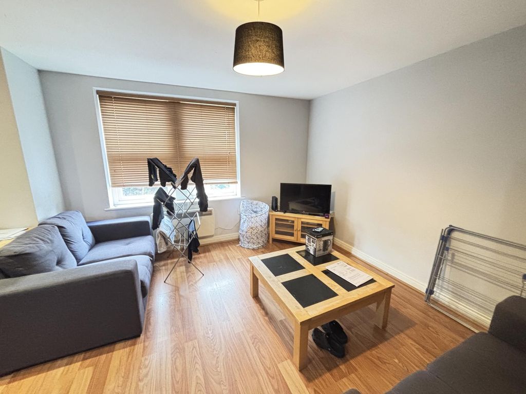 Property photo 1 of 7 A Cozy Living Room Featuring A Comfortable Dark So...