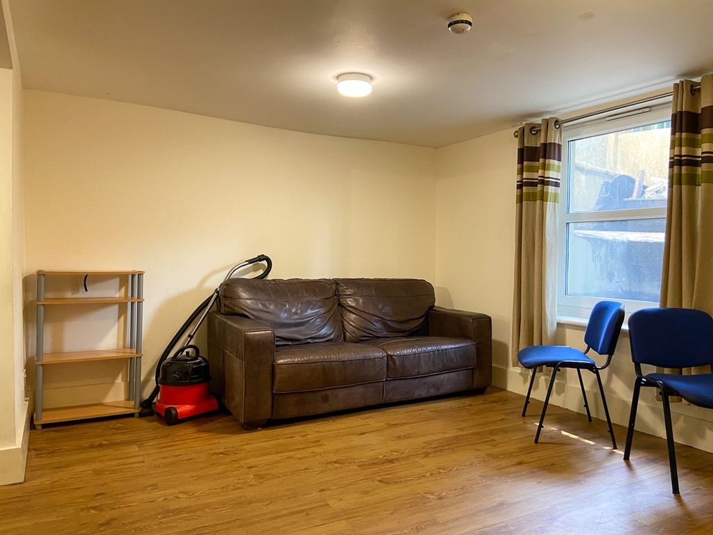 Property photo 1 of 18 A Cozy Living Room With A Brown Sofa, Two Blue Cha...