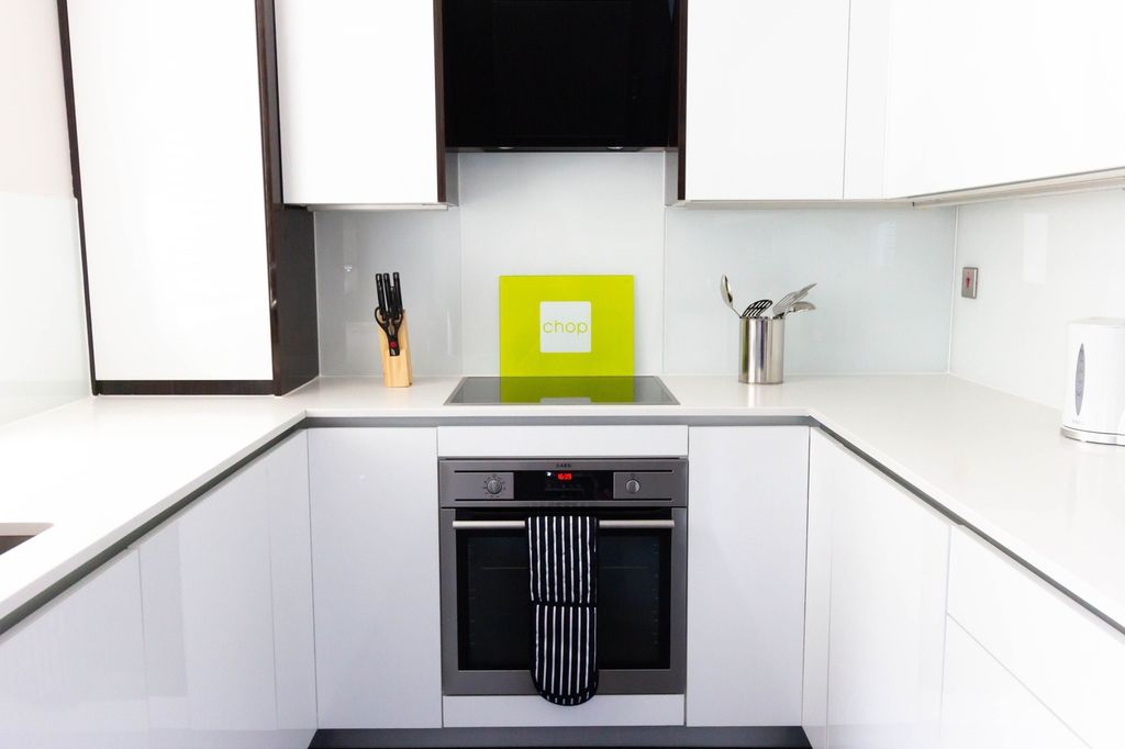 Property photo 3 of 9 A Bright And Modern Kitchen With Sleek White Cabin...
