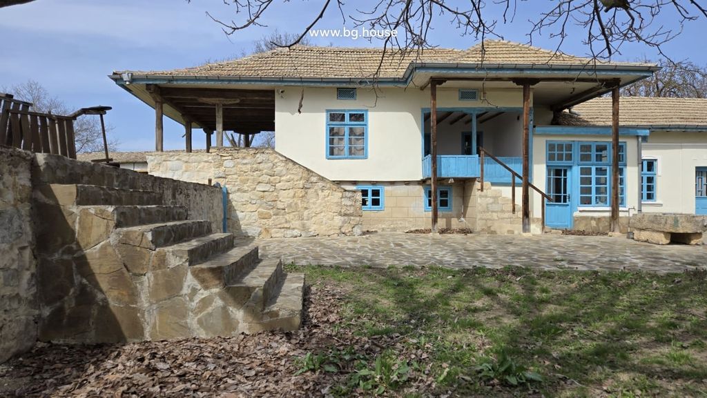 Property photo 3 of 100 Stone Stairs Leading Up To A Covered Balcony With Blue Wooden Railings And Windows On A Traditional House.