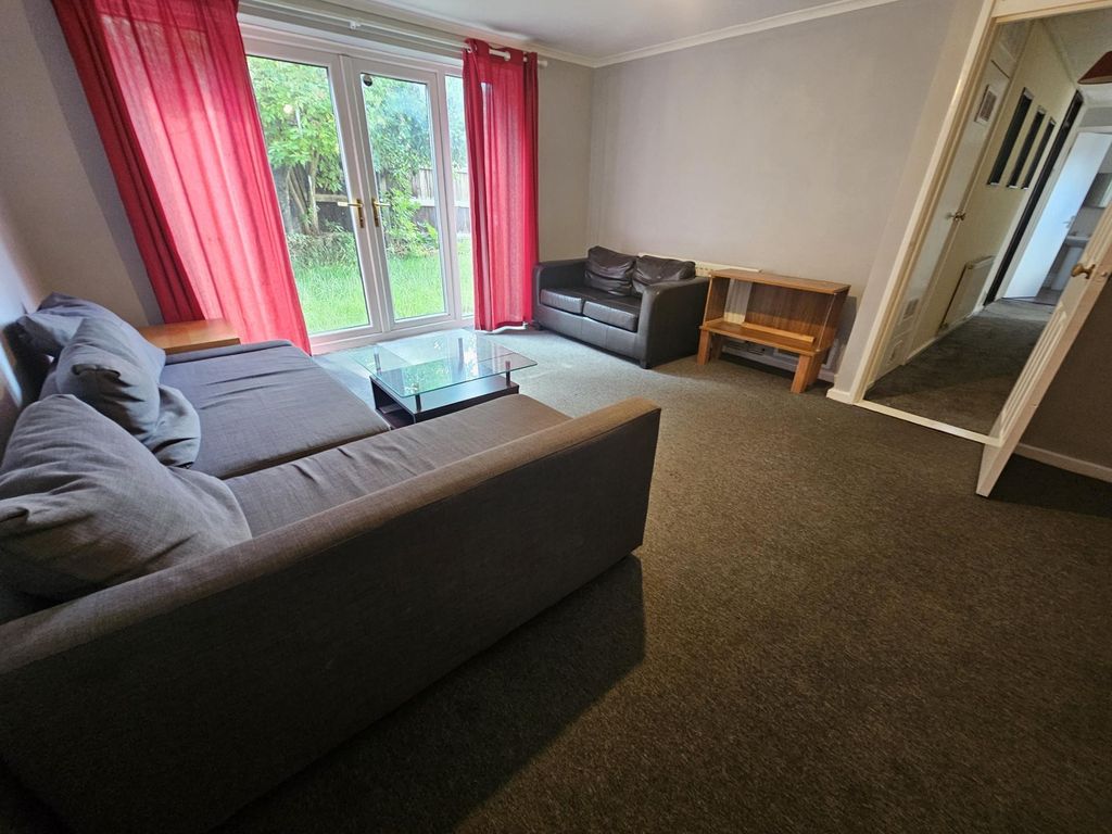 Property photo 3 of 12 A Modern And Inviting Living Room Featuring A Comf...