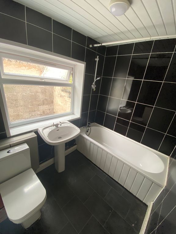 Property photo 2 of 6 A Modern And Inviting Bathroom Featuring A Spaciou...