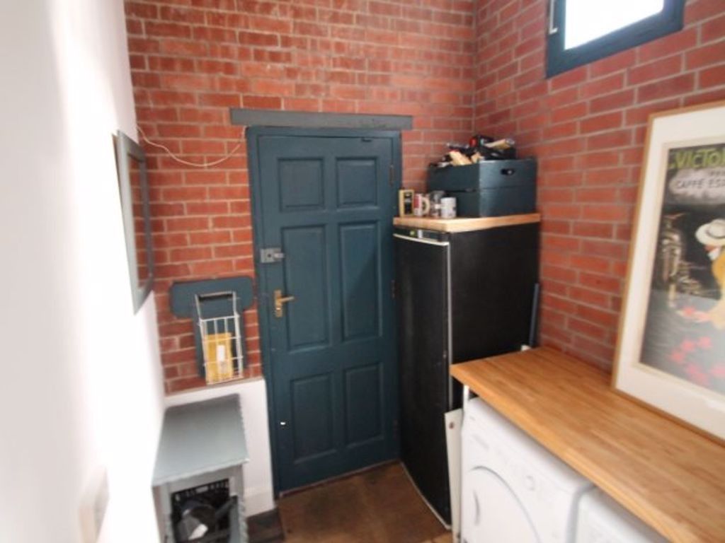 Property photo 3 of 10 A Well-Lit Kitchen Area Featuring A Wooden Counter...