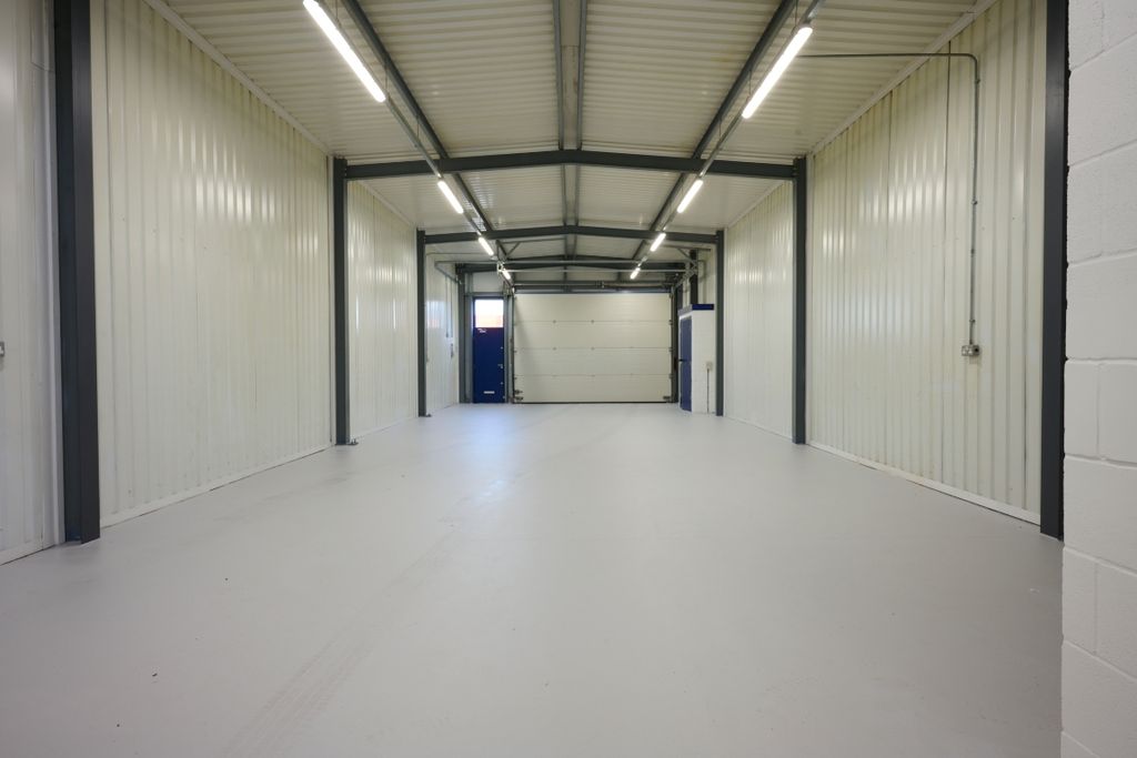 Property photo 2 of 4 The Interior Of A Warehouse Unit, Facing The Front Electric Roller Shutter, Which Is Closed And Large Enough For Vehicle Access.