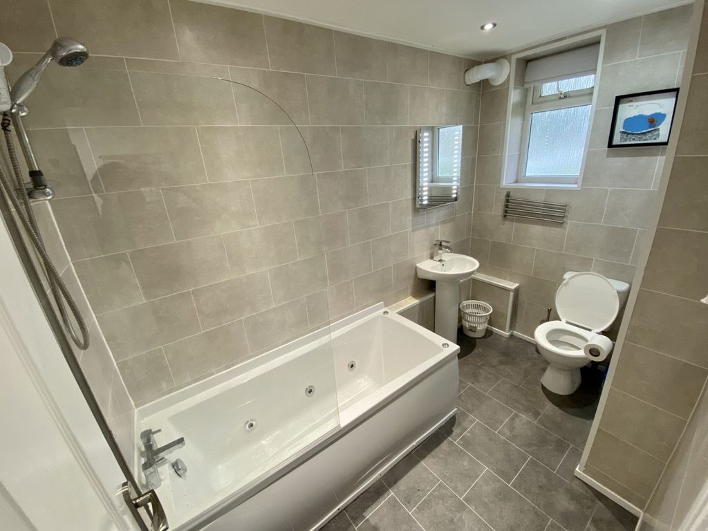 Property photo 1 of 8 A Spacious And Modern Bathroom Featuring A Relaxin...