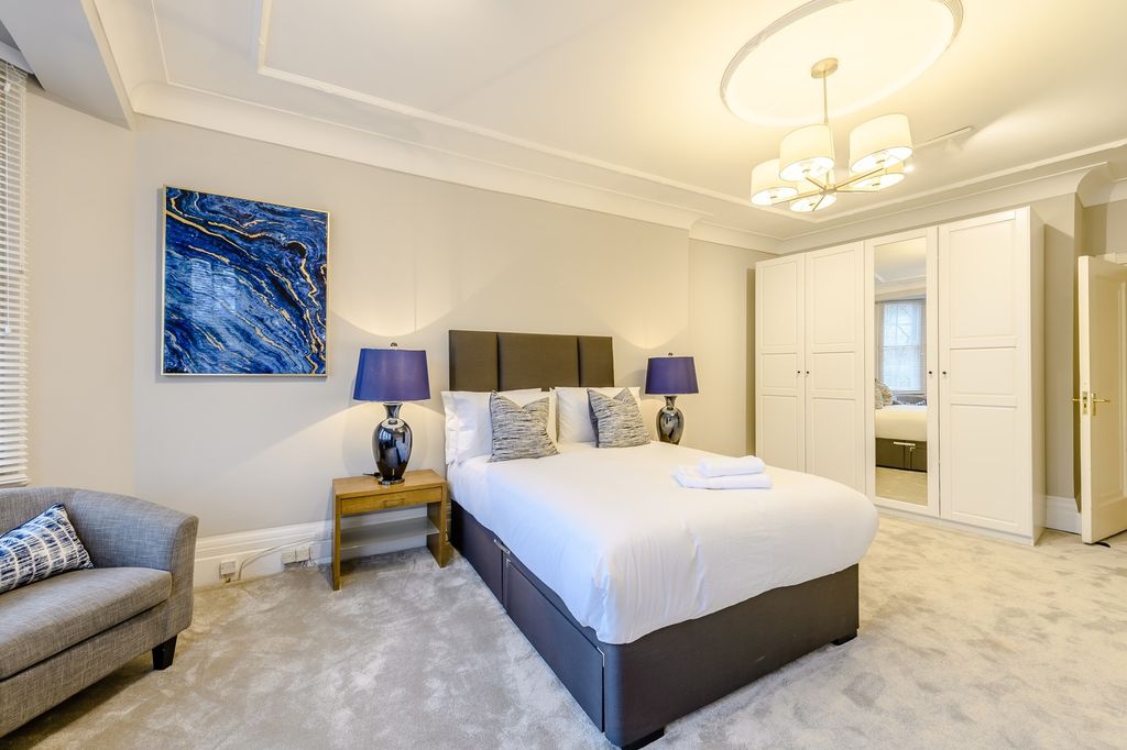 Property photo 2 of 21 Spacious And Stylish Master Bedroom Featuring A Co...