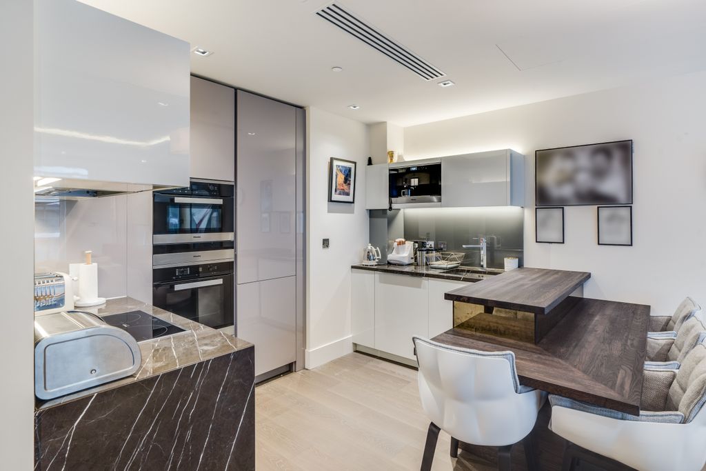 Property photo 2 of 8 Kitchen + Breakfast Bar