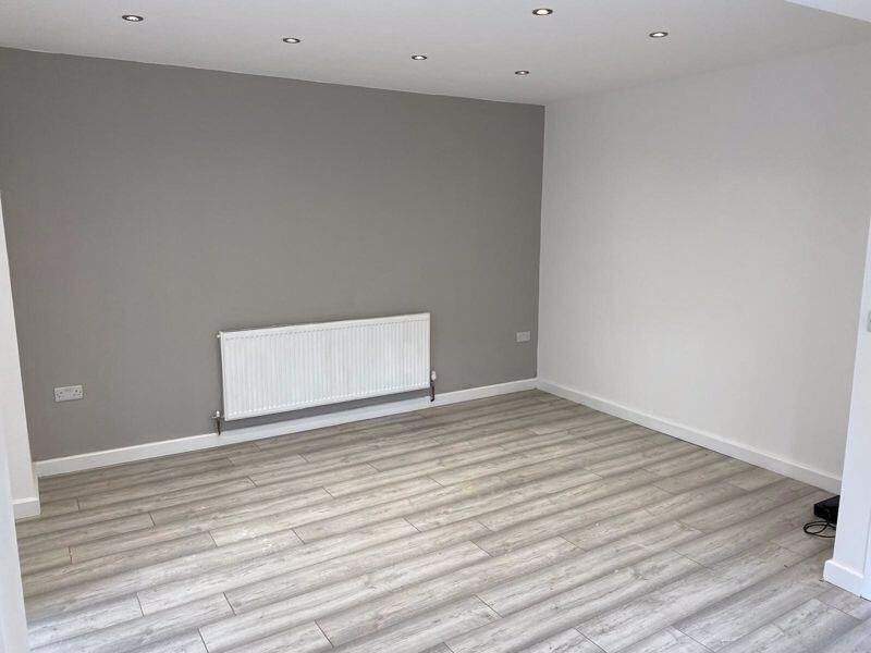 Property photo 1 of 13 A Clean And Modern Living Room Featuring Light Woo...