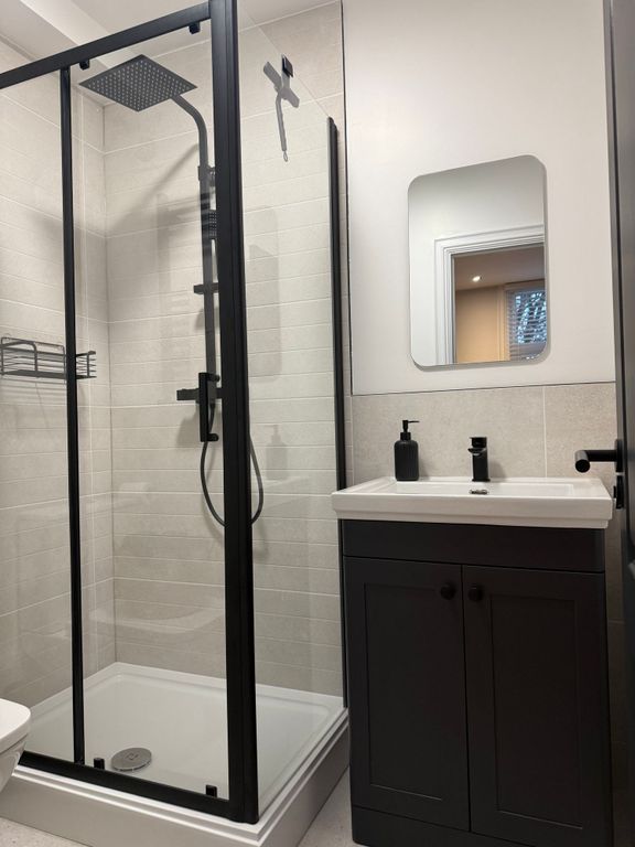 Property photo 2 of 4 A Modern And Clean Bathroom Featuring A Sleek Blac...