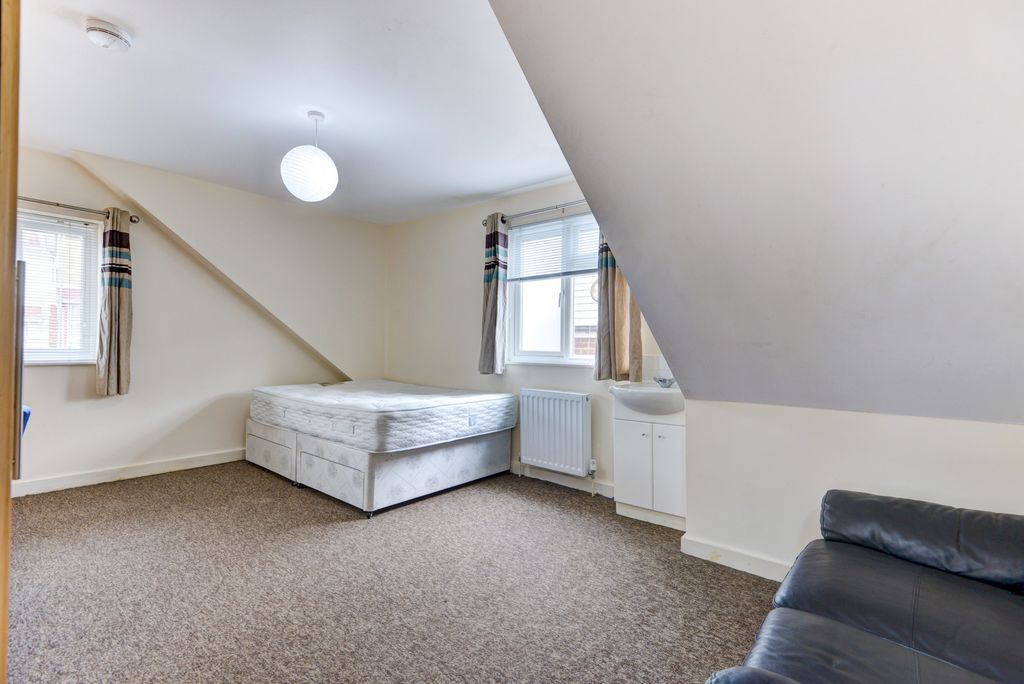 Property photo 1 of 23 Bright And Inviting Living Room Featuring Two Wind...