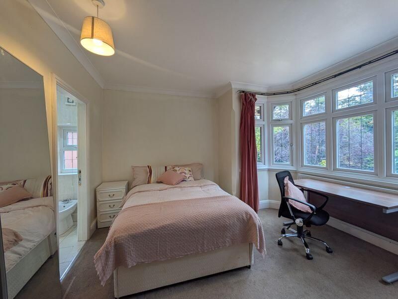 Property photo 3 of 15 A Cozy And Well-Lit Bedroom Featuring A Double Bed...