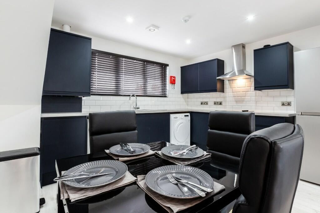 Property photo 2 of 14 Modern Kitchen Featuring Sleek Dark Cabinetry And ...