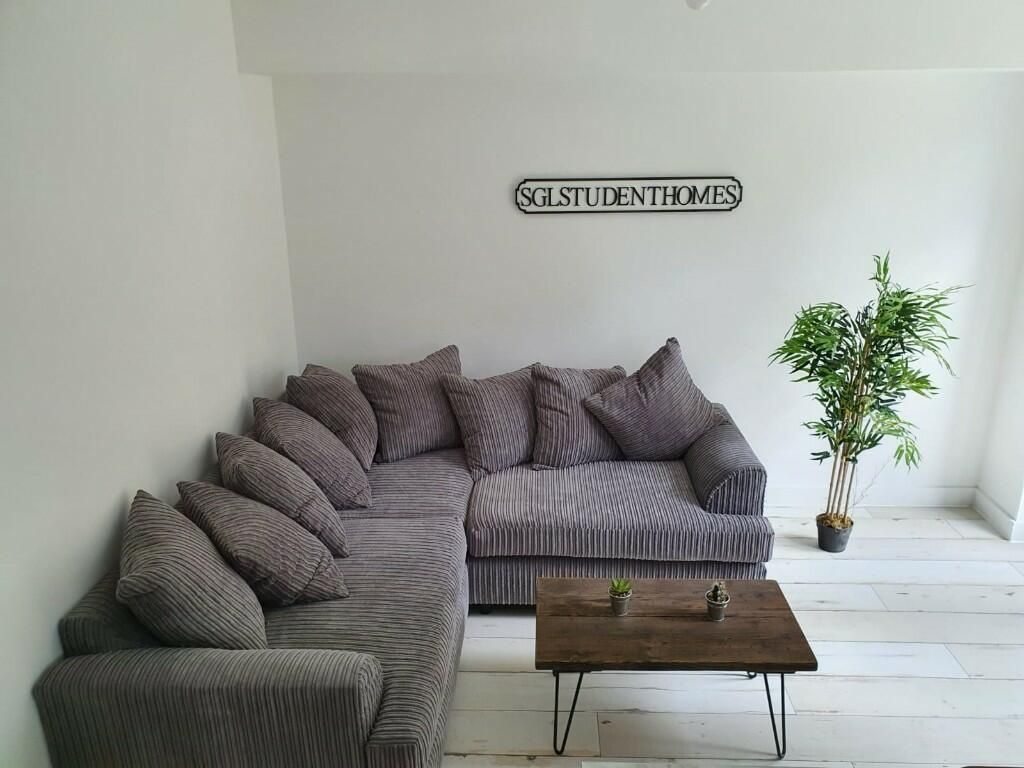 Property photo 2 of 7 A Modern And Inviting Living Room Featuring A Larg...