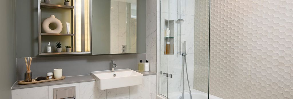 Property photo 3 of 5 Bathroom With Shower Over Bath, Beige Honeycomb Style Tiling, Wash Basin With Mirror, Shelving.