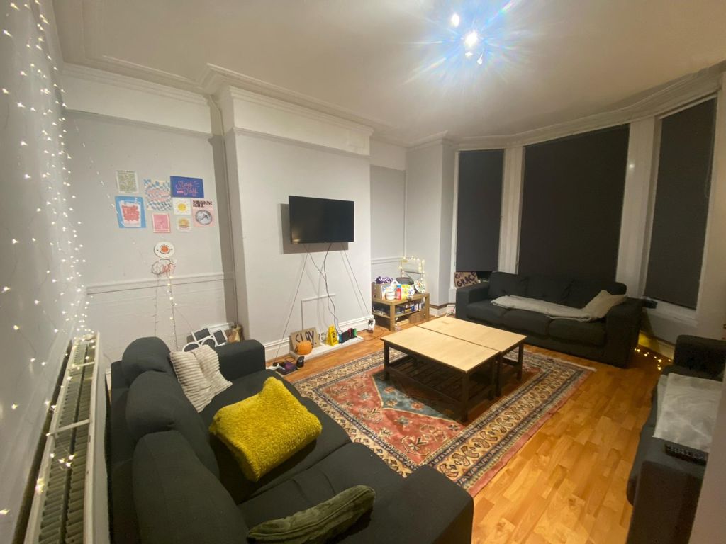 Property photo 2 of 20 A Spacious, Well-Lit Living Room Featuring Modern ...