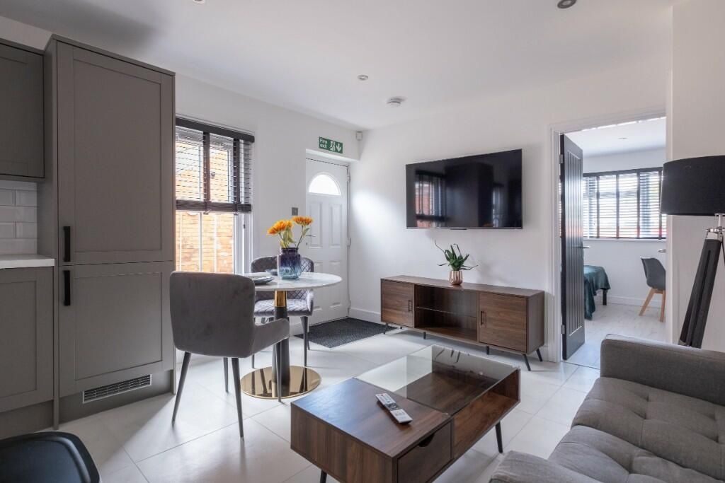 Property photo 3 of 14 A Modern, Well-Lit Living Room With Comfortable Se...