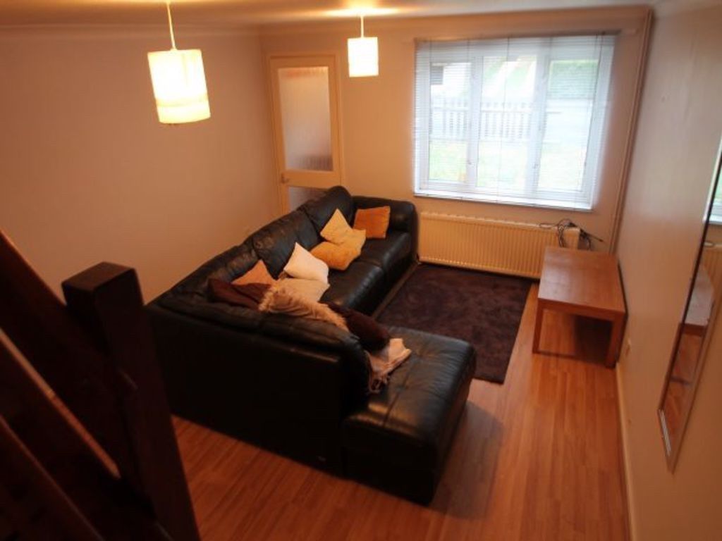 Property photo 2 of 10 A Spacious And Inviting Living Room Featuring Comf...