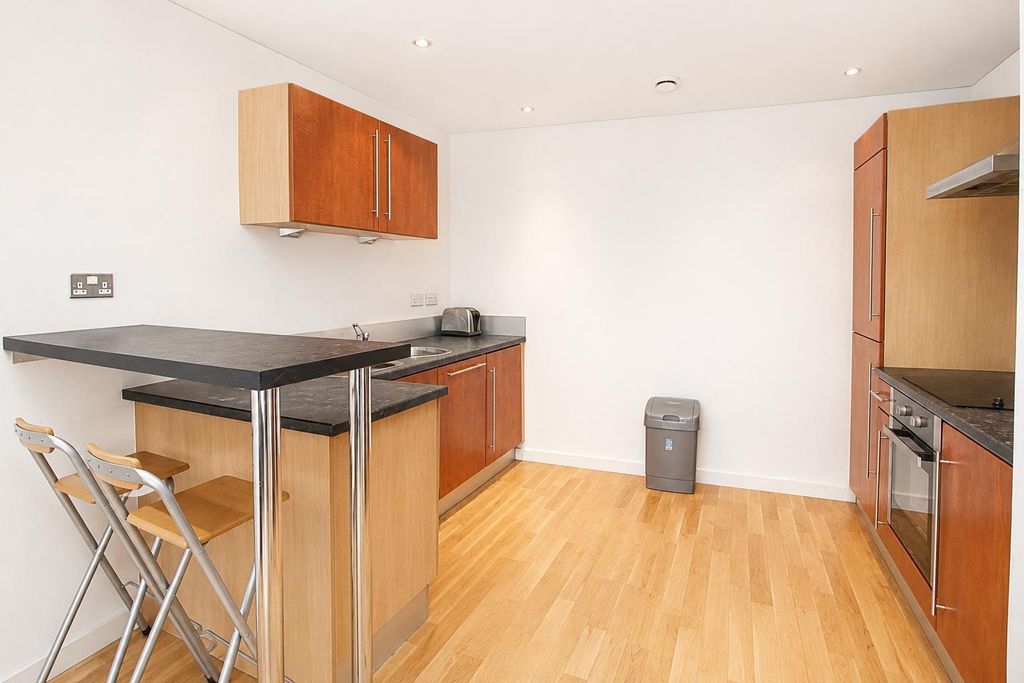 Property photo 3 of 8 Bright Kitchen With Breakfast Bar And Modern Oven...