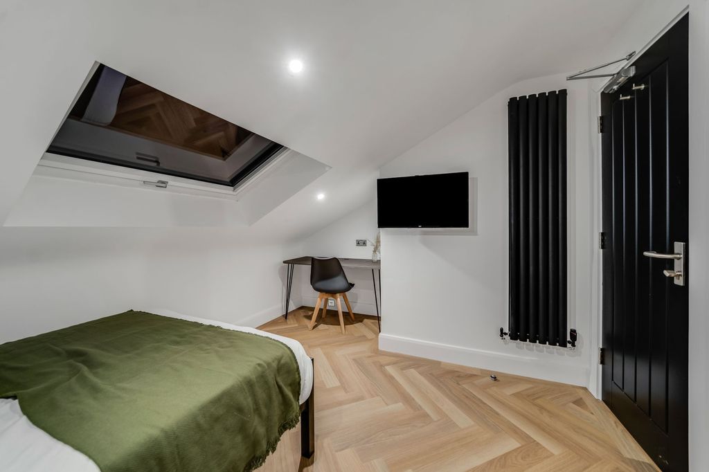 Property photo 2 of 6 A Modern Bedroom With A Sloped Ceiling Featuring A...