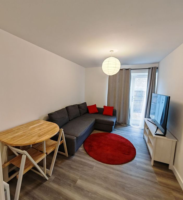 Property photo 3 of 12 A Modern Living Room Featuring A Comfortable Dark ...