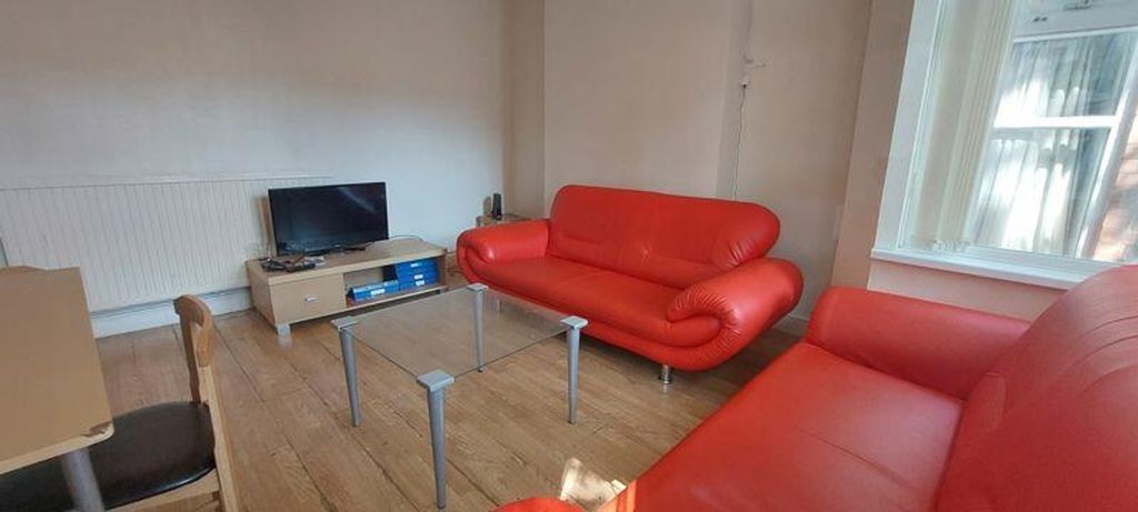 Property photo 1 of 10 A Bright And Inviting Living Room With Modern Red ...