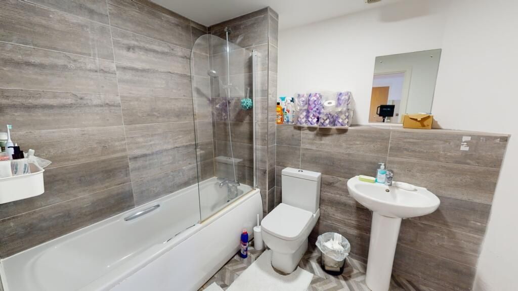 Property photo 3 of 5 A Modern Bathroom Featuring Sleek Grey Tiles, A Sp...