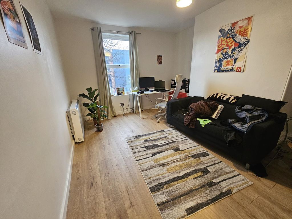 Property photo 1 of 3 A Bright And Inviting Living Room Featuring A Comf...