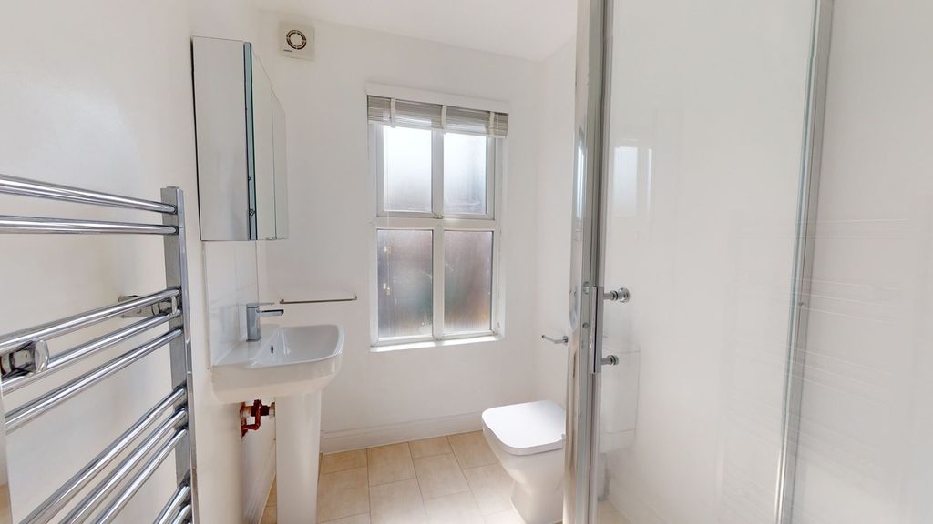 Property photo 2 of 15 A Bright And Modern Bathroom Featuring A Sleek Des...