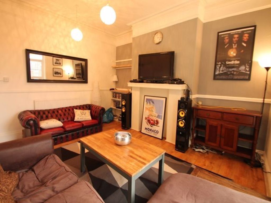 Property photo 2 of 10 A Spacious, Well-Lit Living Room Featuring Comfort...