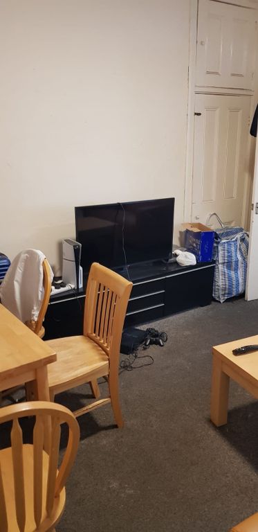 Property photo 1 of 4 A Cozy Living Room Featuring A TV On A Black Stand...