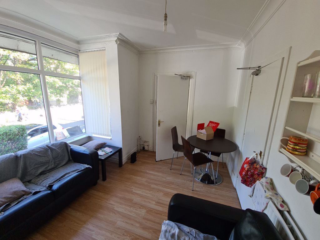 Property photo 2 of 18 A Bright And Inviting Living Room Featuring A Comf...