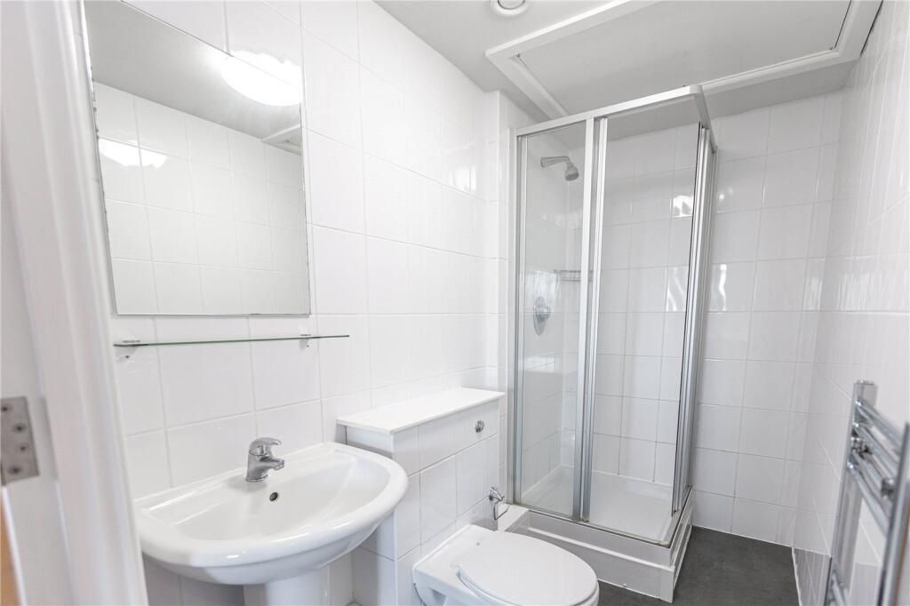 Property photo 3 of 4 Bright And Modern Bathroom Featuring A Clean White...
