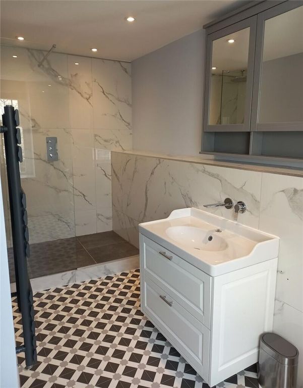 Property photo 3 of 10 A Modern Bathroom Featuring A Spacious Walk-In Sho...