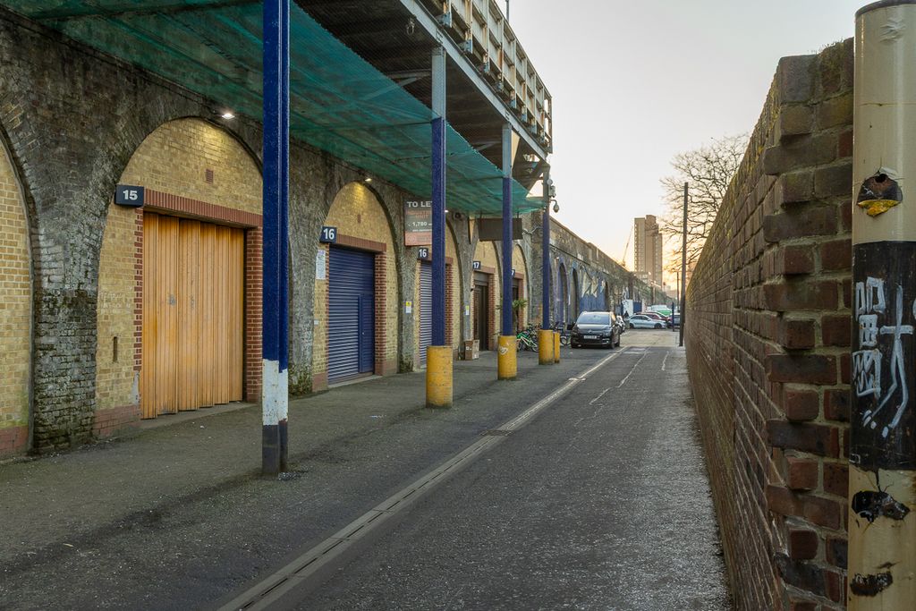 Property photo 3 of 8 An Estate, With Multiple Arches Next To Each Other. The Arches Have Closed Electric Roller Shutter Entrances.