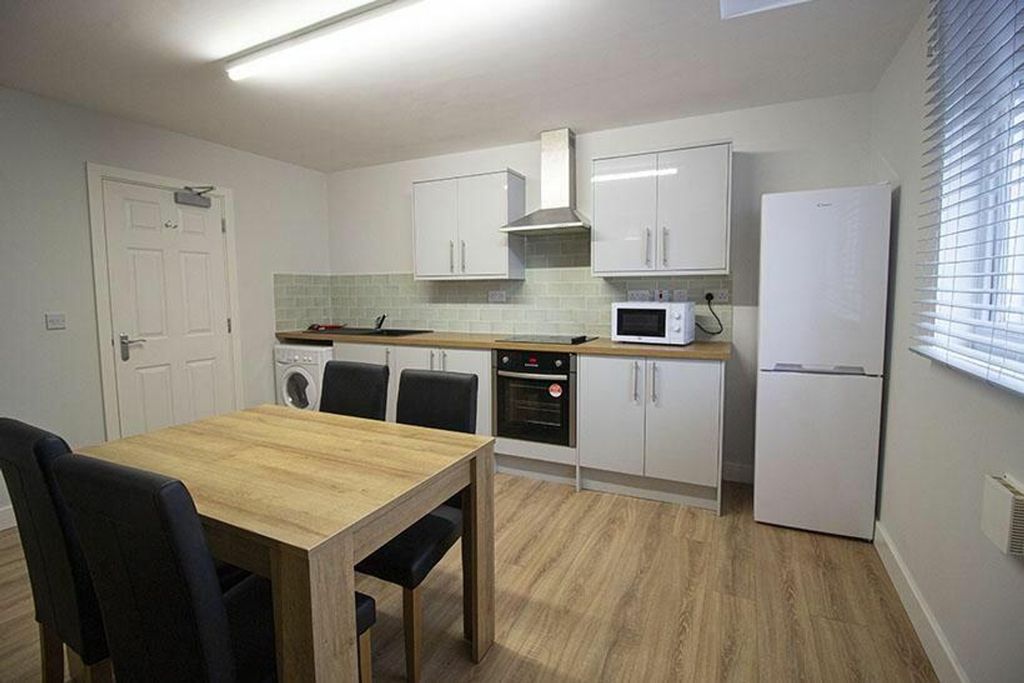 Property photo 3 of 6 A Modern Kitchen Featuring Sleek Cabinetry, Ample ...