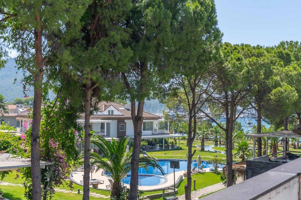 Property photo 1 of 19 A Seafront Duplex Apartment For Sale In Fethiye - Main View Of The Pretty Apartment Block And Gardens