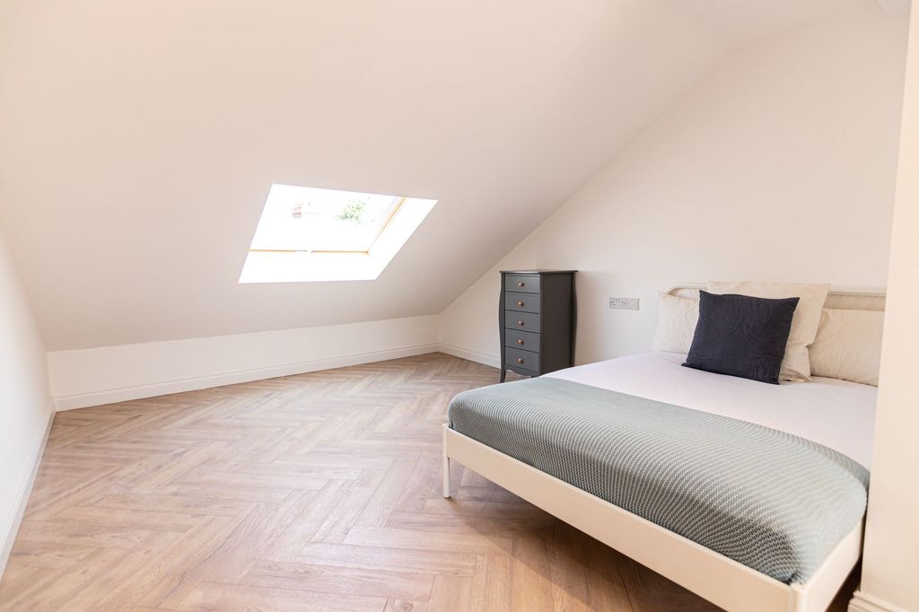 Property photo 1 of 15 Bright And Airy Bedroom Featuring A Comfortable Do...