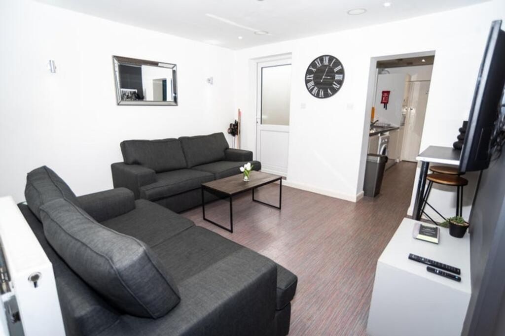 Property photo 2 of 12 This Contemporary Living Room Features Stylish Fur...
