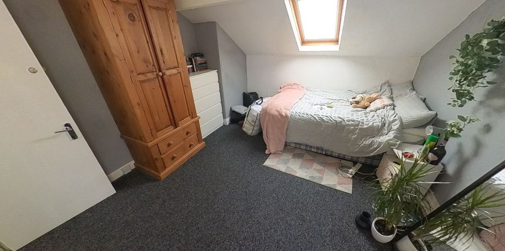 Property photo 3 of 6 A Cozy Single Bedroom Featuring A Bed With A Pink ...