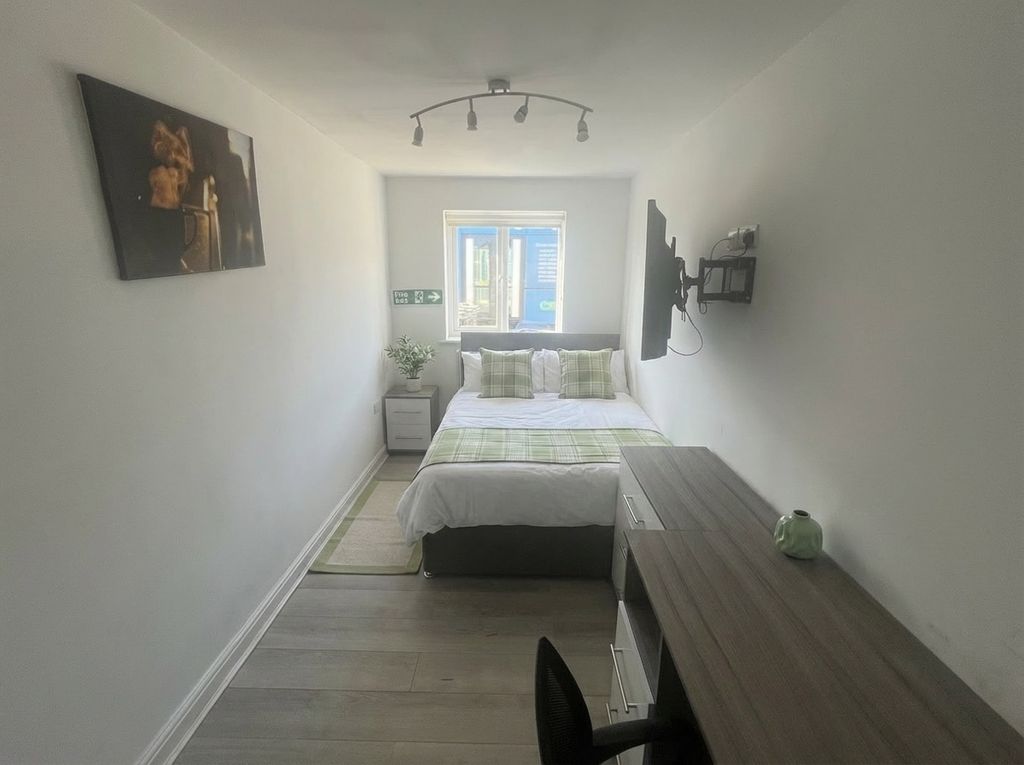 Property photo 1 of 19 Modern Bedroom With A Desk And Wall-Mounted TV...