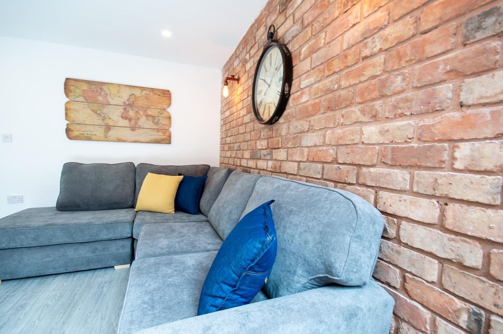 Property photo 1 of 4 A Modern Living Room Featuring A Comfortable Gray ...