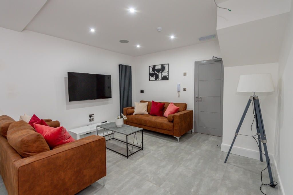 Property photo 3 of 13 A Spacious, Modern Living Room Featuring Two Comfo...