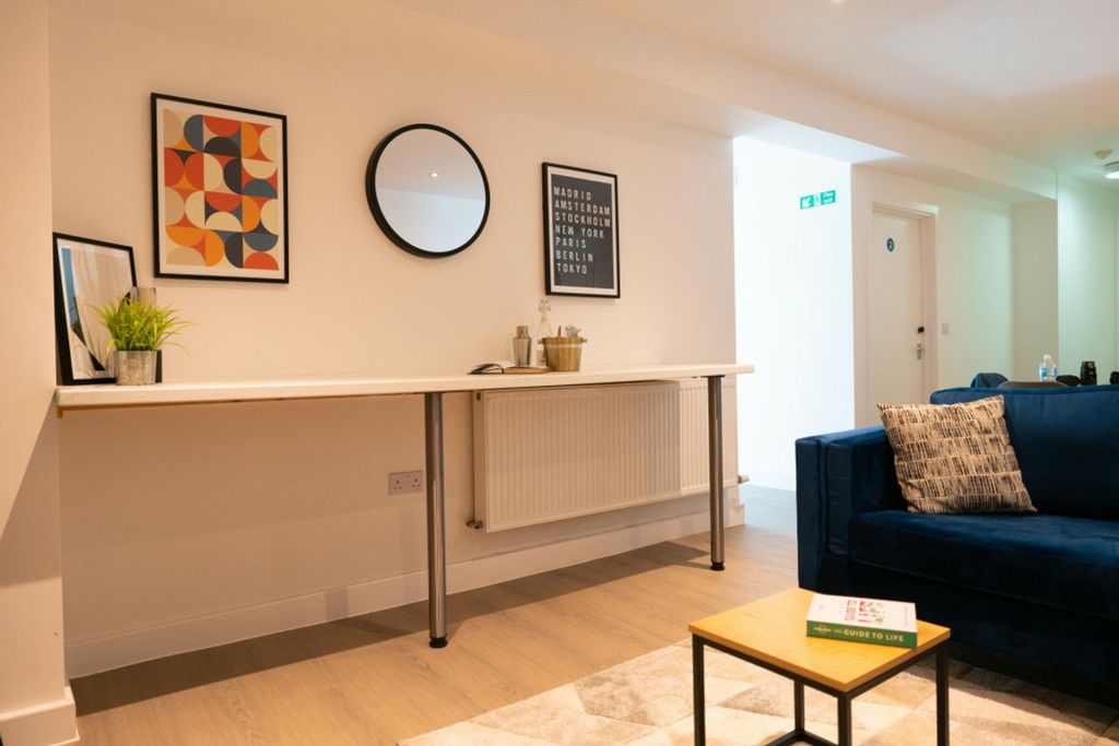 Property photo 3 of 5 This Inviting Living Room Features A Cozy Blue Sof...