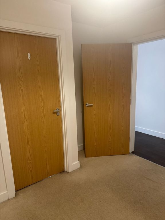 Property photo 3 of 5 Bright, Neutral Hallway With Wooden Doors...