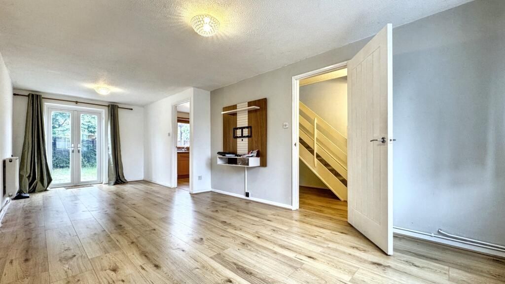 Property photo 1 of 14 Bright And Spacious Living Room Featuring Light Wo...
