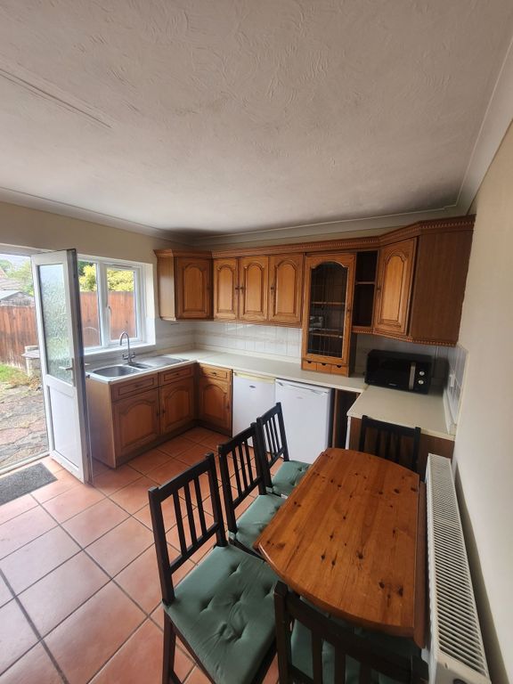 Property photo 3 of 12 Bright And Welcoming Kitchen Featuring Classic Woo...